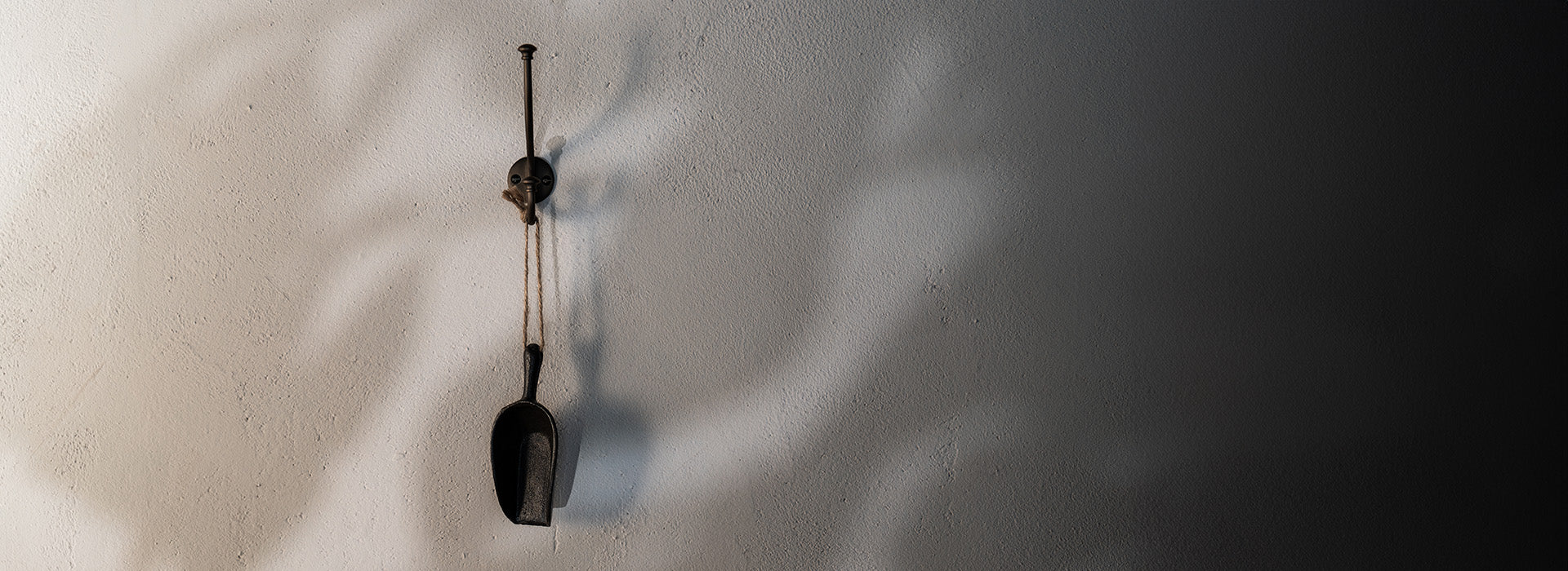 Bronze door handle by Corston on wooden door