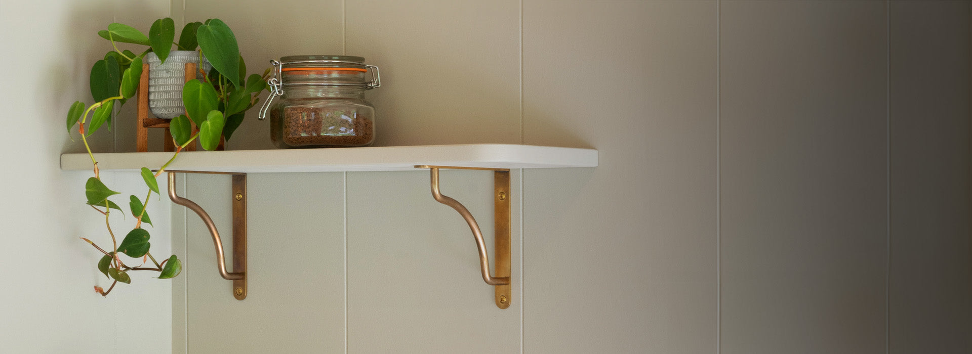 bronze shelf brackets with white marble shelves